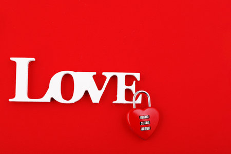 inscription love and red hearts on a red background close-up close-upの写真素材