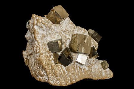 Macro stone Pyrite mineral in rock on a black background close up