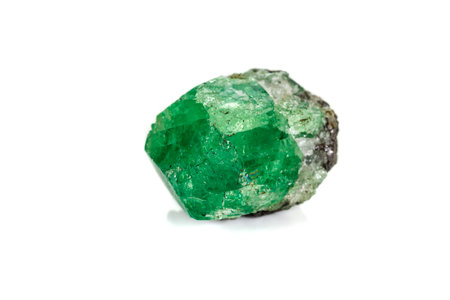 Macro stone garnet mineral, Uvarovite in rock on a white background close up