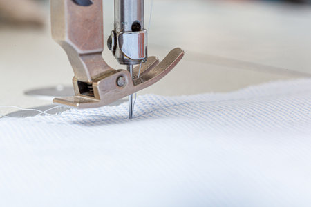 Sewing machine needle with thread and fabric close-upの写真素材