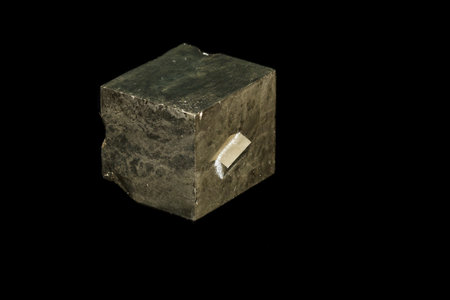 Macro mineral stone Pyrite on a black background close up