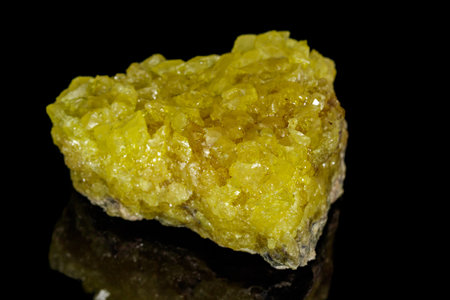 Macro of a sulfur mineral stone on a black background close up