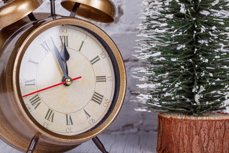 alarm clock, Christmas tree, gifts Christmas toys on the background of a brick wall close-up