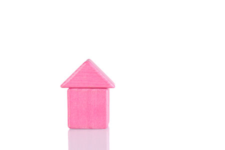 Wooden house of pink color on a white background close-upの写真素材