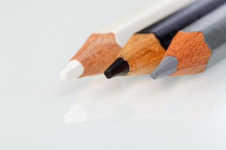 white, gray and black pencil on a white background close-upの写真素材