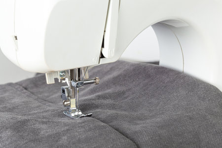 Sewing machine, stitching fabrics, needle in a round plan close up