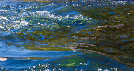 flow of water and spray from a stone close up
