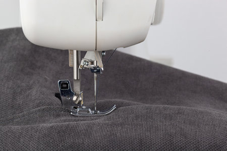 Sewing machine, stitching fabrics, needle in a round plan close up