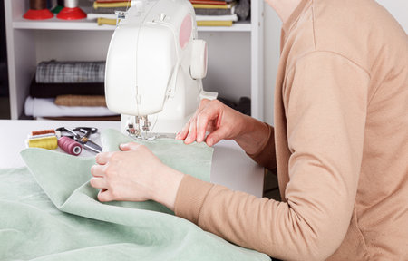 Sewing machine, stitching fabrics, needle in a round plan close up
