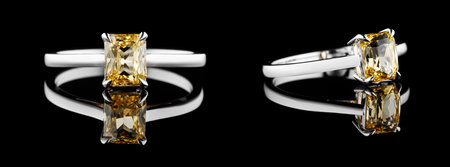 Beautiful white gold ring with yellow sapphire and diamonds on a black backgroundの写真素材