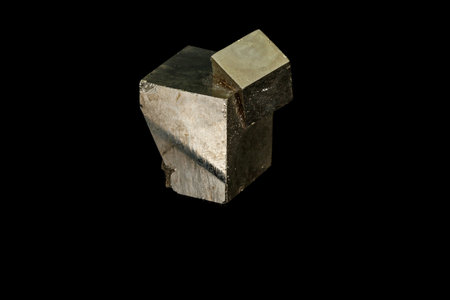 Macro mineral stone Pyrite on a black background close up