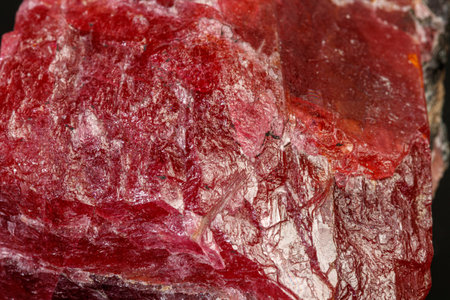 macro mineral Rhodonite stone on a black background close-up