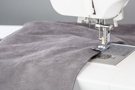 Sewing machine, stitching fabrics, needle in a round plan close up