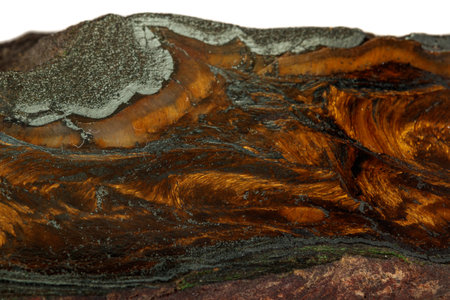 Macro stone tiger eye mineral in rock on black background close up