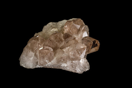 Macro mineral stone smoky quartz, rauchtopaz on a black background close up