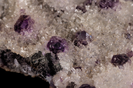 macro mineral fluorite stone on black background close up