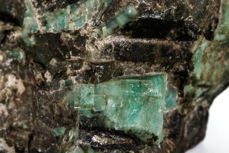 Macro emerald stone mineral in rock on white background close upの写真素材