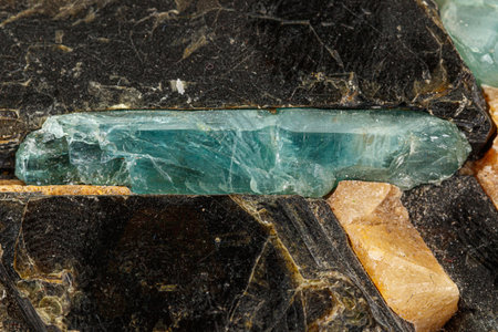Macro aquamarine mineral stone in rock on white background close up