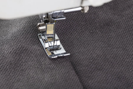 Sewing machine, stitching fabrics, needle in a round plan close up