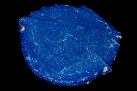 Macro mineral stone Azurite in siltstone against black background close up