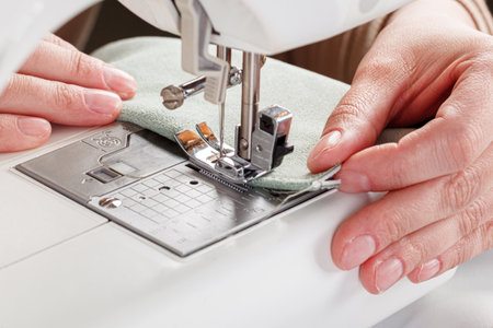 Sewing machine, stitching fabrics, needle in a round plan close up
