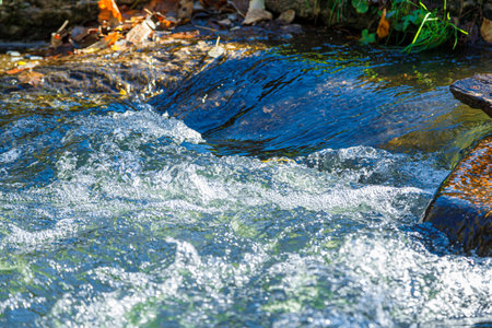 flow of water and spray from a stone close up