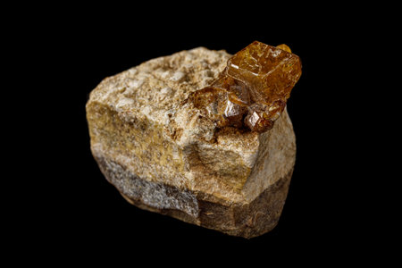 Macro stone Grossular mineral on a black background close up