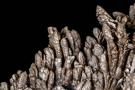 Macro of a stone Stibnite mineral on a black background close up