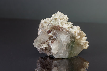 macro mineral stone Apophyllite stilbite on a gray background close up