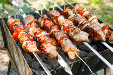 Cooking barbecue with vegetables on skewers. Roasted meat on the grill close-upの写真素材