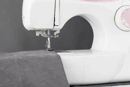Sewing machine, stitching fabrics, needle in a round plan close up