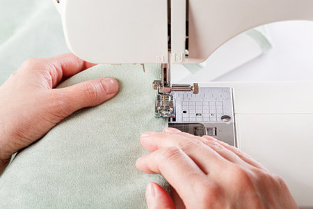 Sewing machine, stitching fabrics, needle in a round plan close up