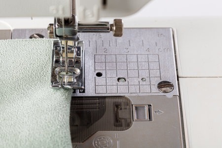 Sewing machine, stitching fabrics, needle in a round plan close up