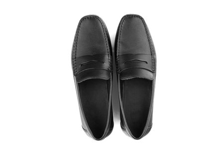 men's pair of black moccasins on isolated white background close-upの写真素材