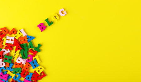 colored letters of the alphabet on a yellow background close-upの写真素材