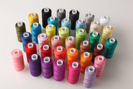 Set of colorful spools of thread close up