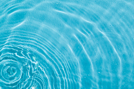 drops on water with circles on a blue background close up