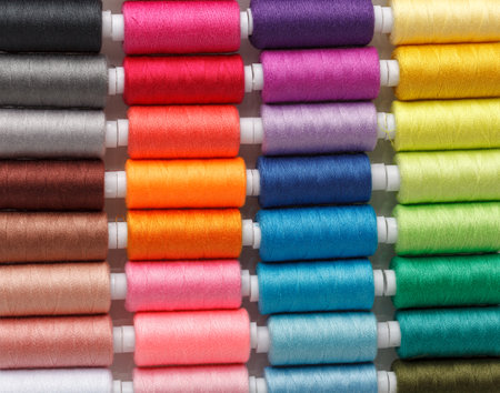Set of colorful spools of thread close up