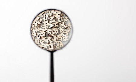 wooden letters english alphabet with lens on white background close upの写真素材