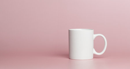 white cup for tea or coffee on a pink background close-upの写真素材