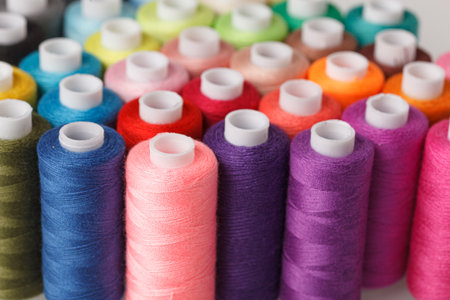 Set of colorful spools of thread close up