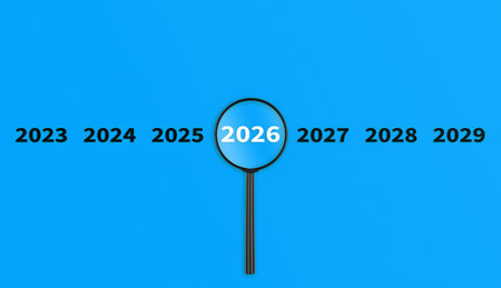 Lens, magnifying glass focusing on the year 2026 on a Blue background. Financial or stock market...