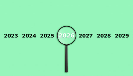 Lens, magnifying glass focusing on the year 2026 on a Green background. Financial or stock market...