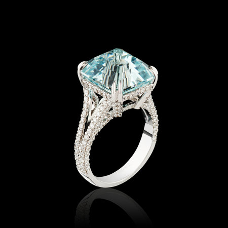 Beautiful white gold ring with diamonds and aquamarine on a black background close-upの写真素材