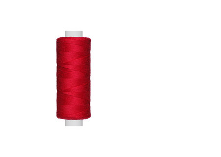 Red spool of sewing thread isolated on white background close up