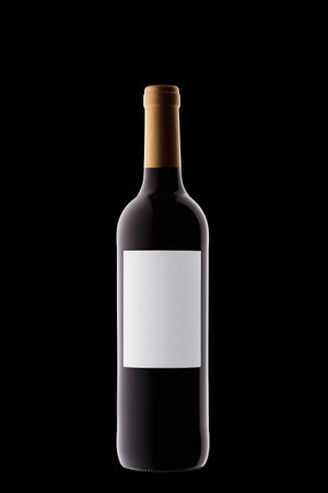 Bottle of wine with a white label with beautiful highlights on a black background close-upの写真素材