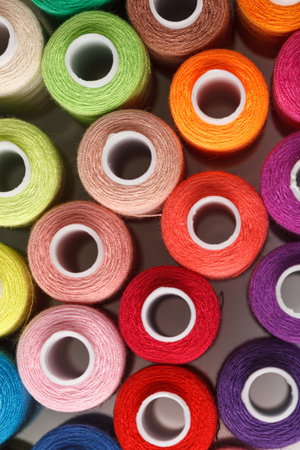 Set of colorful spools of thread close up