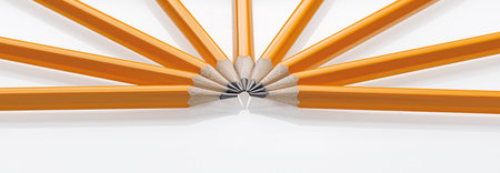 sharpened yellow graphite pencils arranged in a fan on white background. Perfect for school supplies and creative projects, close upの写真素材