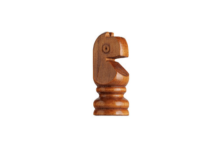 Macro shot of a wooden brown knight chess piece on white background. Ideal for strategy and gaming concepts.の写真素材