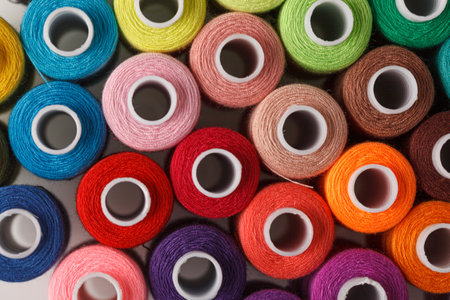 Set of colorful spools of thread close up